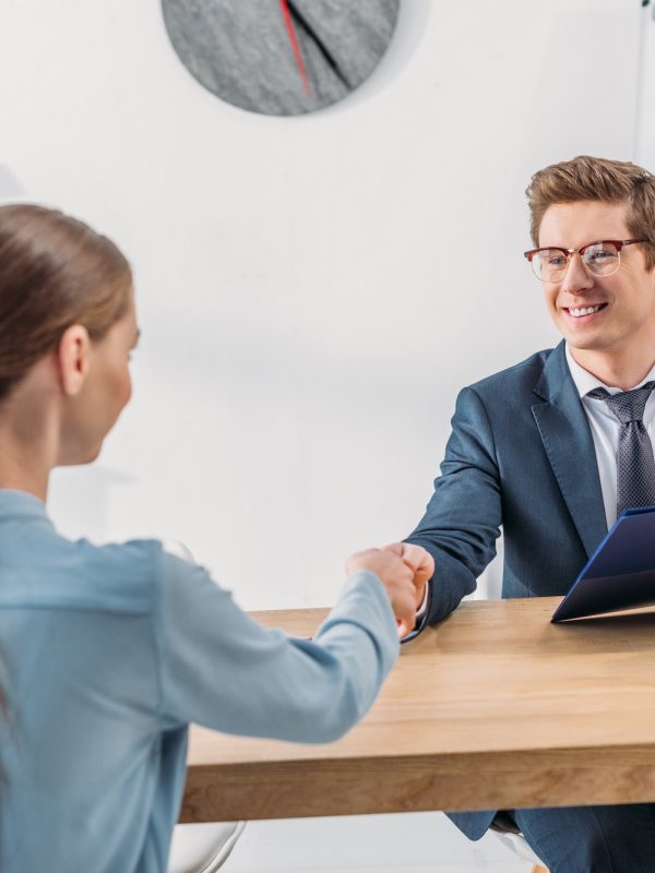woman-shaking-hands-with-cheerful-recruiter-in-glasses-holding-clipboard.jpg interview